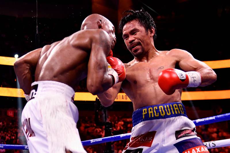 Manny Pacquiao and Yordenis Ugas of Cuba during the bout. AFP