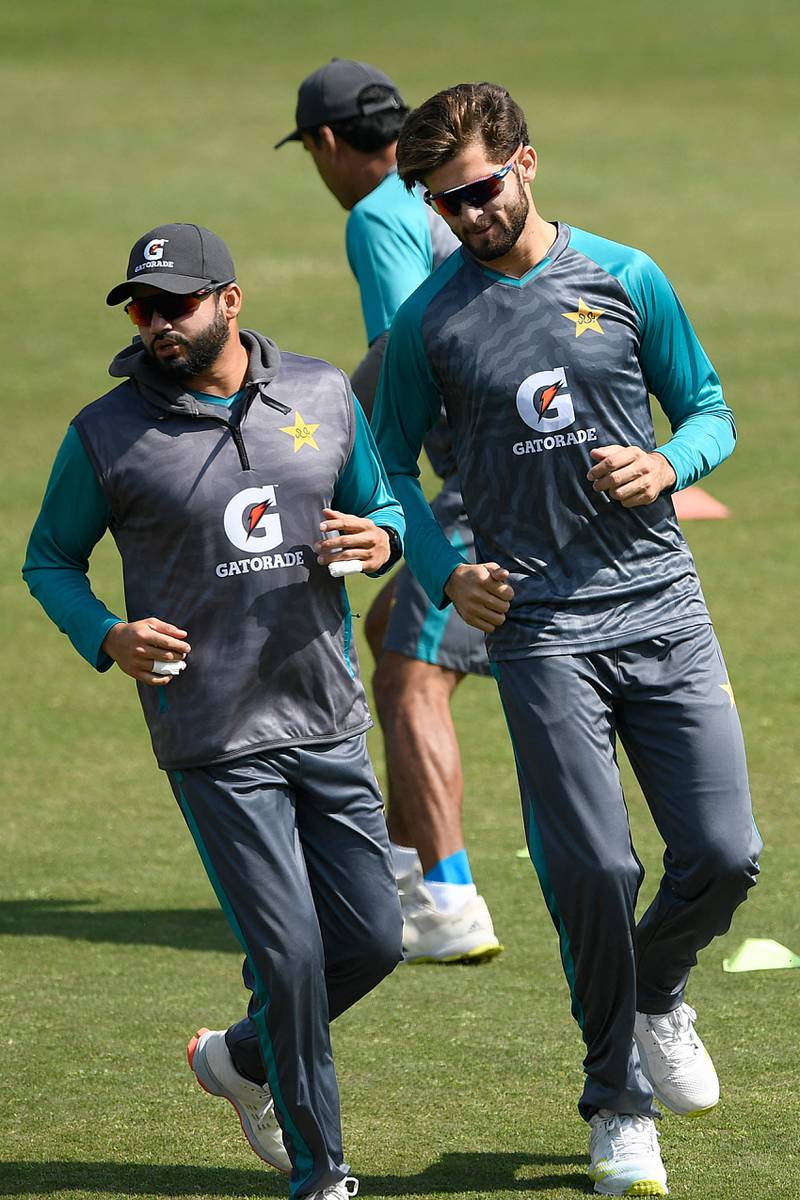Pakistan's Azhar Ali, left, and Shaheen Shah Afridi warm up during a practice session. AFP