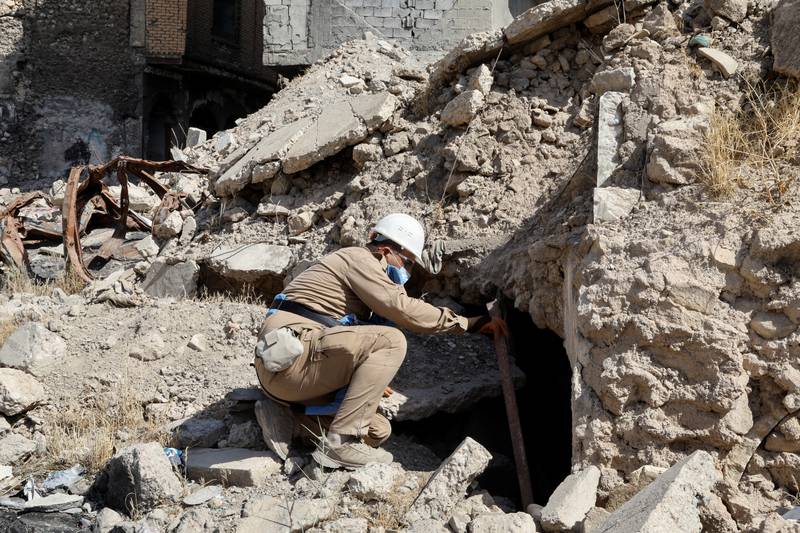 A member of a demining squad takes part in an operation to clear mines in the Old City of Mosul.