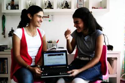 October 24, 2011, Dubai, UAE:

Boushra (left), 15, and Line Dalile(right), 14, have just passed their TOEFL proficiency exams. The girls have also already lectured at a TED conference and are currently eyeing university. They managed to do all of this on their own, using each other and online courses as their sole teachers. 

They are seen here in the bedroom they share, holding Boushra's laptop, which has her online TOEFL degree on the screen.
Lee Hoagland/The National