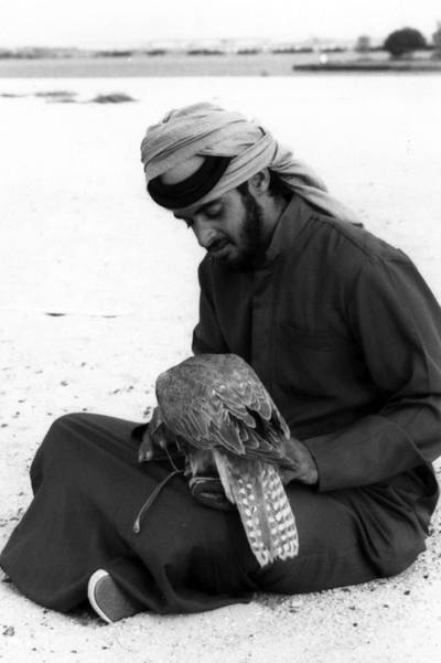Back in Abu Dhabi, Sheikh Mohamed tends to a falcon at the Falconers Club. Photo: National Archives