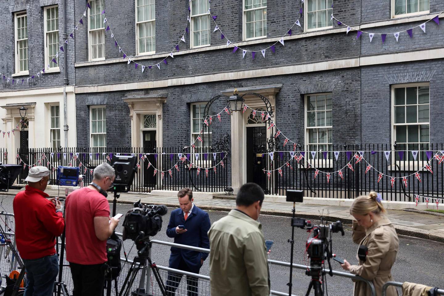 Members of the media wait outside of 10 Downing Street on Monday morning. AFP