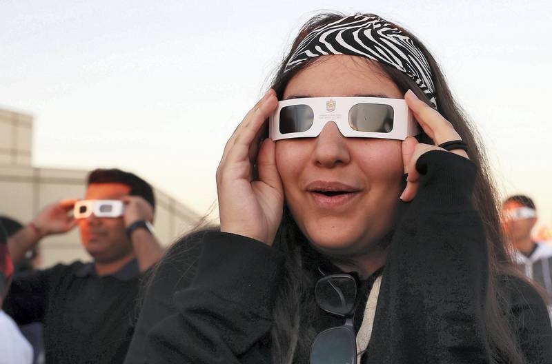 DUBAI, UNITED ARAB EMIRATES, Dec 26 – 2019 :- People watching the solar eclipse at the Al Thuraya Astronomy Center in Mushrif park in Dubai. They are wearing solar eclipse glasses to watch the eclipse. ( Pawan Singh / The National ) For News/Instagram 