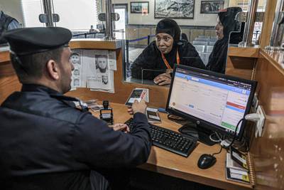 A passport control officer checks the travel documents of a Palestinian pilgrim at the Rafah crossing point with Egypt in the southern Gaza Strip. AFP