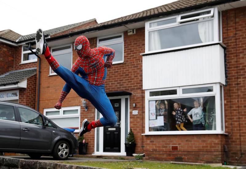 Jason Baird is seen dressed as Spiderman during his daily exercise to cheer up local children in Stockport, as the spread of the coronavirus disease (COVID-19) continues, Stockport, Britain. REUTERS