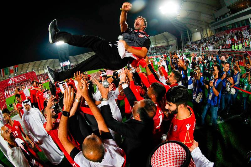 Bahrain players throw their coach Helio Souza into the air to celebrate beating Saudi Arabia 1-0 to win the 24th Arabian Gulf Cup. AFP