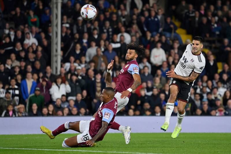 Aleksandar Mitrovic of Fulham shoots under pressure from Tyrone Mings of Aston Villa and Ashley Young. Getty Images