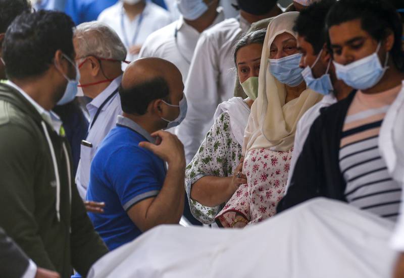 Dilip Kumar's wife Saira Banu, centre, with the actor's body at a hospital in  Mumbai on Wednesday.