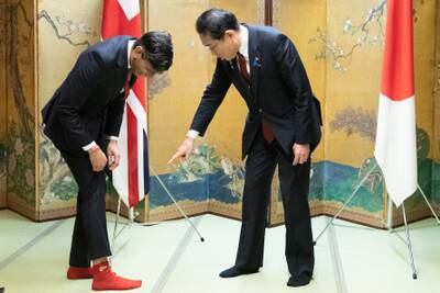 UK Prime Minister Rishi Sunak and Japan's Prime Minister Fumio Kishida discuss baseball themed socks. Getty 