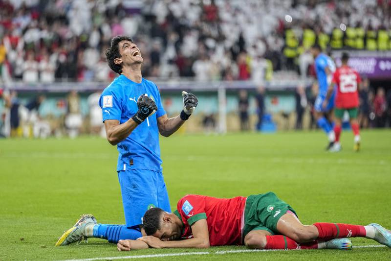 Morocco's goalkeeper Yassine Bounou, left, celebrates with Achraf Hakimi after guiding their team to the World Cup semi-final. AP