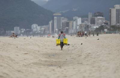 A vendor walks on Ipanema beach during the coronavirus disease (COVID-19) outbreak in Rio de Janeiro. REUTERS