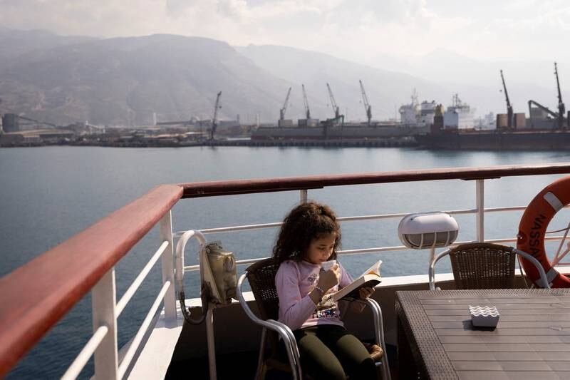A girl drinks tea while reading a book on a docked cruise ship that serves as a temporary shelter for earthquake survivors in Iskenderun, Turkey. Reuters