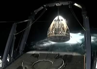 The SpaceX capsule is lifted out of the water. Photo: Nasa