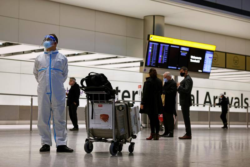 A man wears personal protective equipment at the arrivals area, as tighter rules for international travellers start, at Heathrow Airport. Reuters