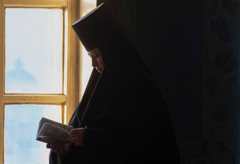 A nun reads a prayer book during the Orthodox Christmas service at Saint Nicholas convent in Mogochino, in the Tomsk region, Russia. Reuters