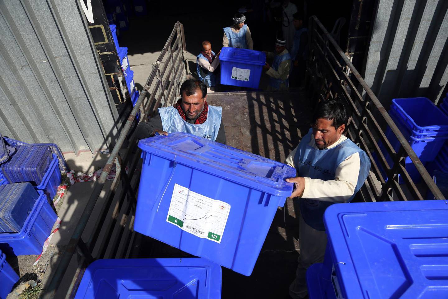 In this Monday, Sept. 23, 2019 photo, Afghan election workers load ballot boxes and other election materials on a truck for distribution at the Independent Election Commission compound, in Kabul, Afghanistan. Millions of Afghans are expected to go to the polls on Saturday to elect a new president, despite an upsurge of violence in the weeks since the collapse of a U.S.-Taliban deal to end Americaâ€™s longest war, and the Taliban warning voters to say away from the polls. (AP Photo/Rahmat Gul)