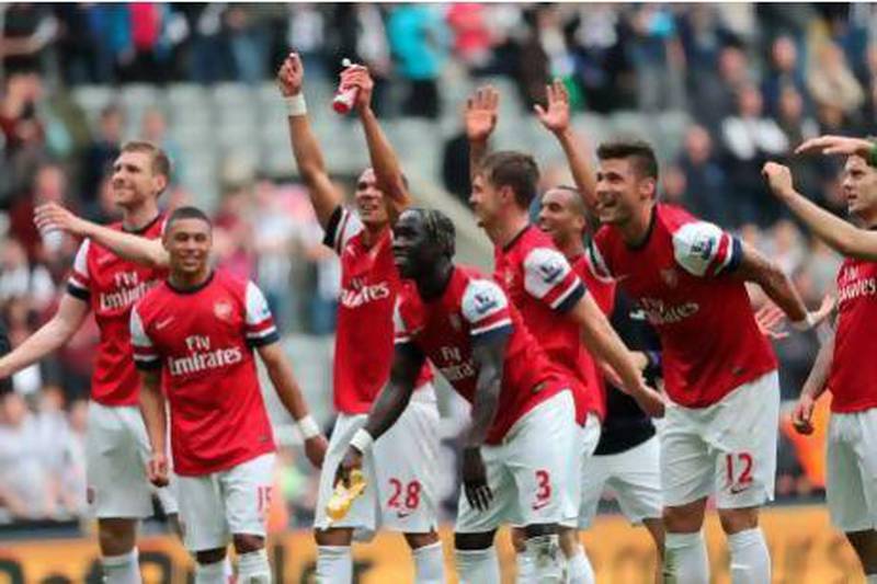 Arsenal players celebrate their victory Sunday, which secured fourth place in the table. Ian MacNicol / AFPn