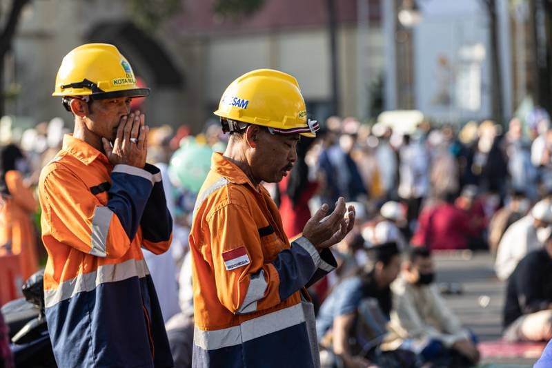 Workers perform prayers in Malang, Indonesia. Getty Images