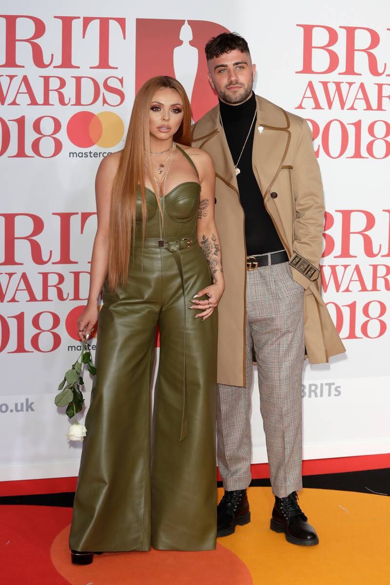 Jesy Nelson, in a khaki leather jumpsuit, with Harry James at The Brit Awards 2018 on February 21, 2018