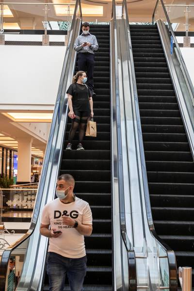 DUBAI, UNITED ARAB EMIRATES. 24 MAY 2020. The first day of the Eid holidays saw shoppers head to Mall of the Emirates to shop for both food and luxury items. Mall staff have put in place thermal scanning at entry ways and shops are supplying hand santizer and in some cases glothes when shoppers enter the stores. Social distancing is also being observed for the most part as restrictions are in place by Dubai Government. (Photo: Antonie Robertson/The National) Journalist: Kelly Clarke. Section: National.