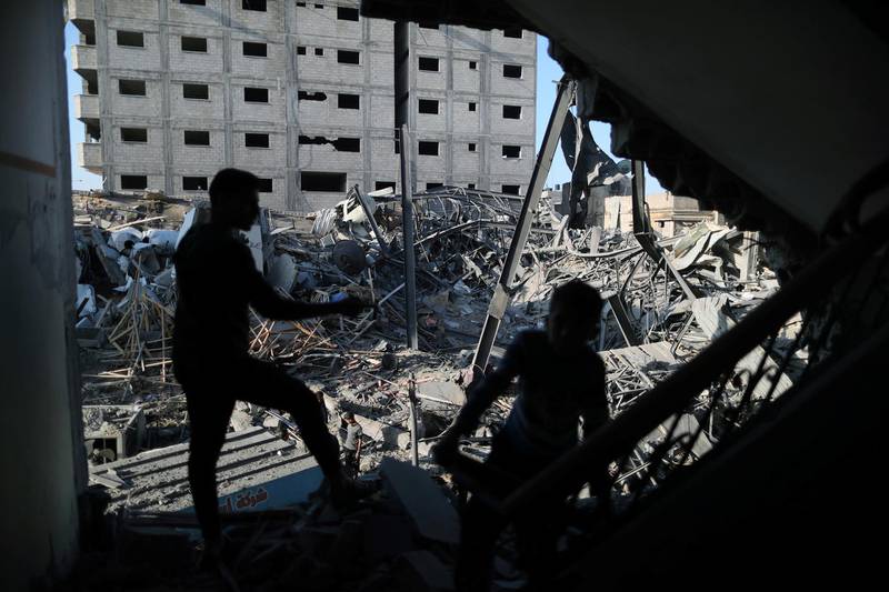 A Palestinian looks at the remains of Hamas's TV station building that was destroyed by Israeli air strikes. Reuters