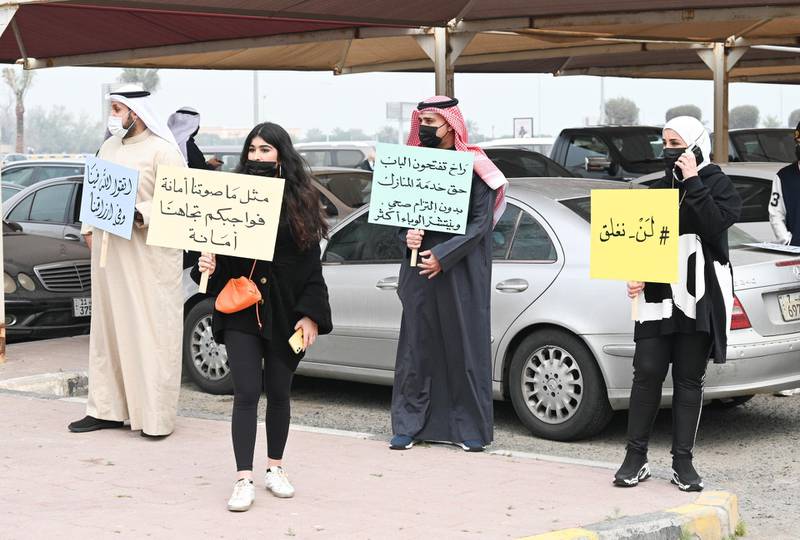 Business owners display placards during an anti-closures protest in Kuwait City. The Kuwaiti government stopped non-Kuwaitis entering the country for two weeks starting from February 7 to prevent the spread of the coronavirus.  EPA