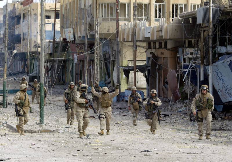 US marines from the 3/5 Lima company walk along the destroyed high street after taking an important bridge in the restive city of Fallujah in November 2005. AFP