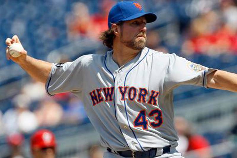 New York Mets starting pitcher R.A. Dickey (43) delivers in the eighth inning of a baseball game against the Washington Nationals, Thursday, July 19, 2012, in Washington. Dickey earned his league-leading 13th win in the Mets' 9-5 victory.  (AP Photo/Carolyn Kaster)
