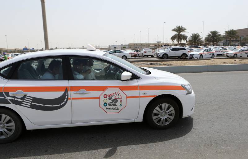 ABU DHABI - UNITED ARAB EMIRATES - 09APR2015 - White and orange driving school cars teaching driving to the residence around the Emirates driving company in Mussafah in Abu Dhabi. Ravindranath K /The National (to go with Ramona story for News) *** Local Caption ***  RK0904-Drivingschools07.jpg