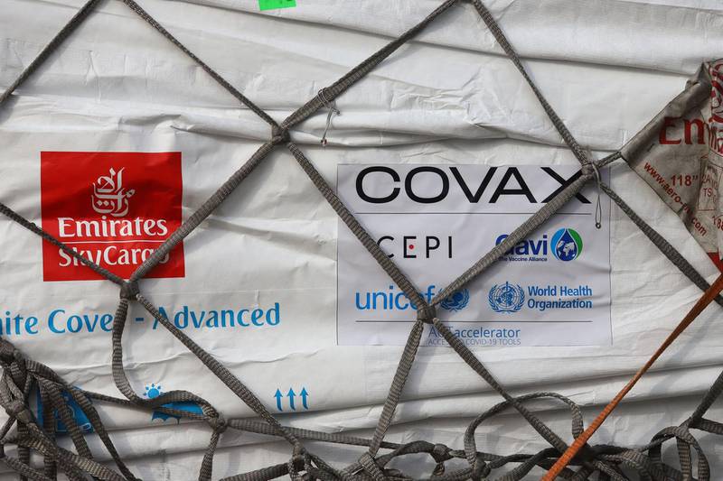 An Emirates logo is seen next to a Covax tag on a batch of Covid-19 vaccines at Kotoka International Airport in Accra, Ghana. AFP