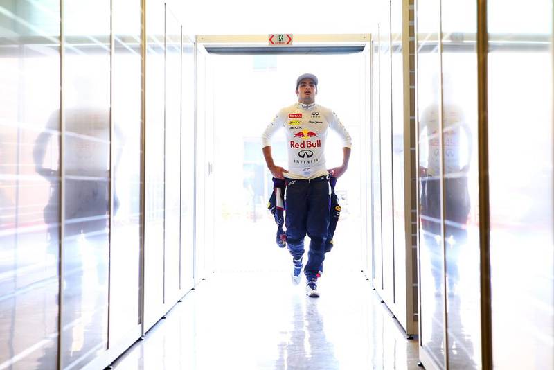 Carlos Sainz Jr. of Spain and Infiniti Red Bull Racing walks into the garage during day one of Formula One testing at Yas Marina Circuit on November 25, 2014 in Abu Dhabi, United Arab Emirates.  (Photo by Dan Istitene/Getty Images)