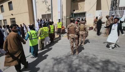 Pakistani security officials stand guard as victims of the suicide bomb blast in Mastung are brought to hospitals in Quetta. EPA