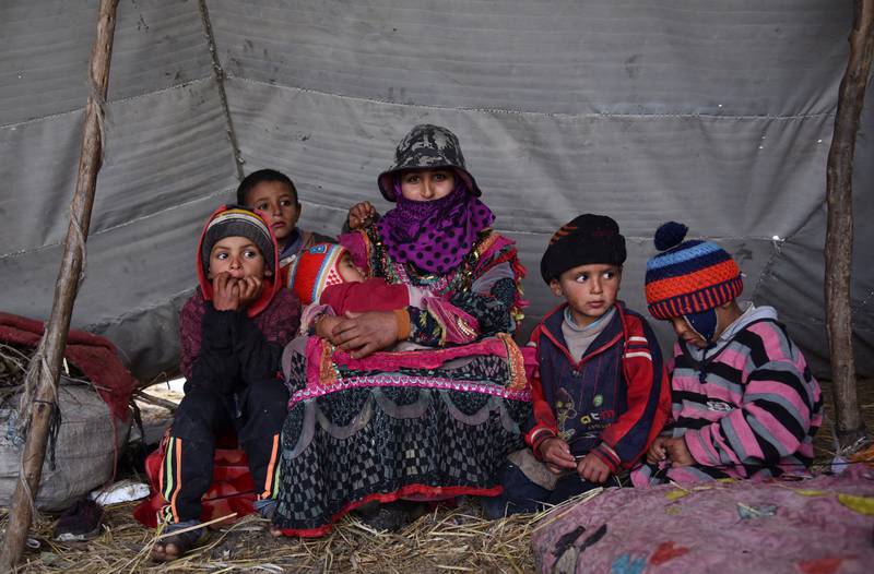 Thanaa Abeda with her children in a tent in Kafr El Sheikh.