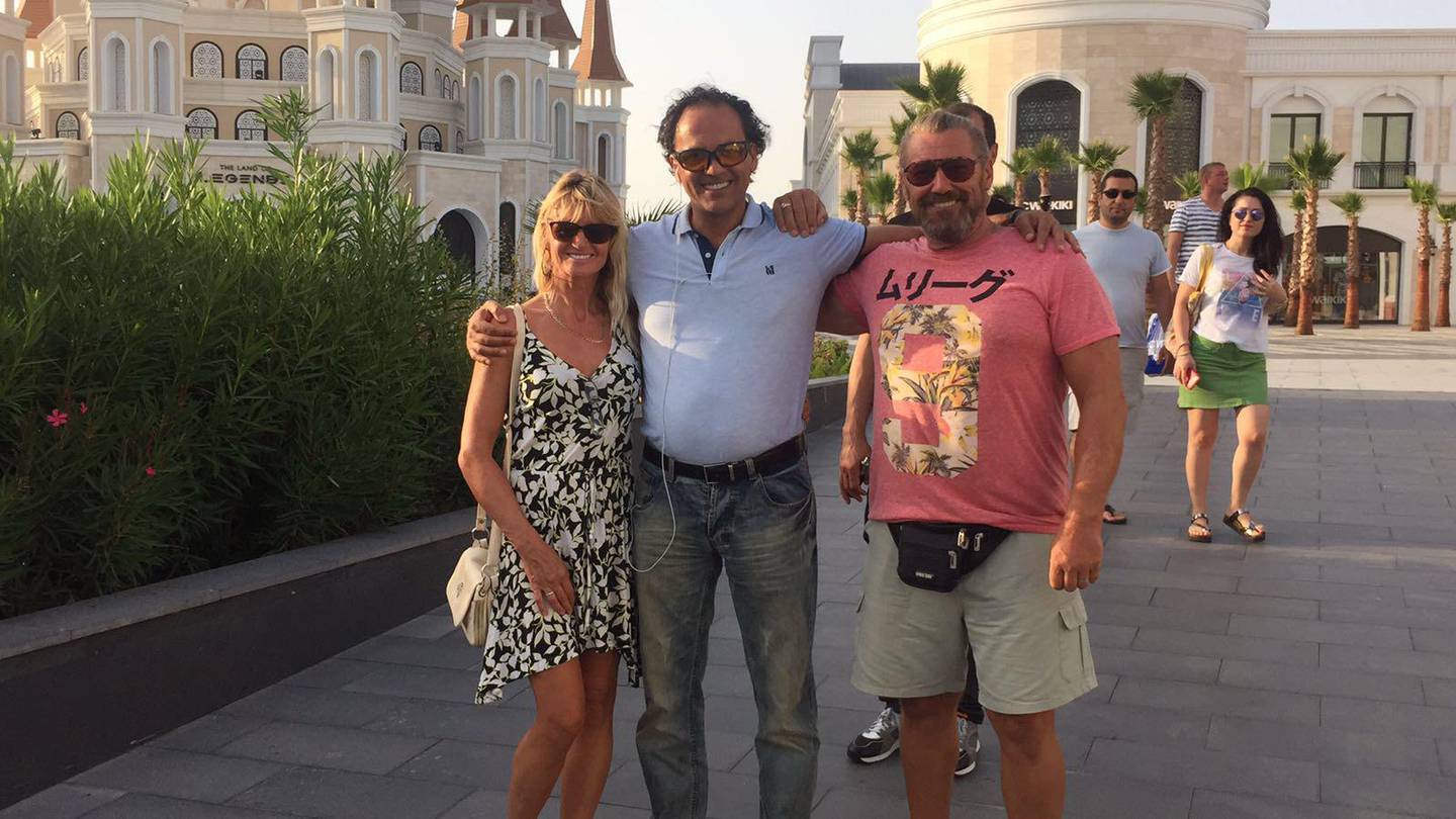 Harun Sevimli, pictured between actor Mike Mitchell and his wife. Courtesy Harun Sevimli