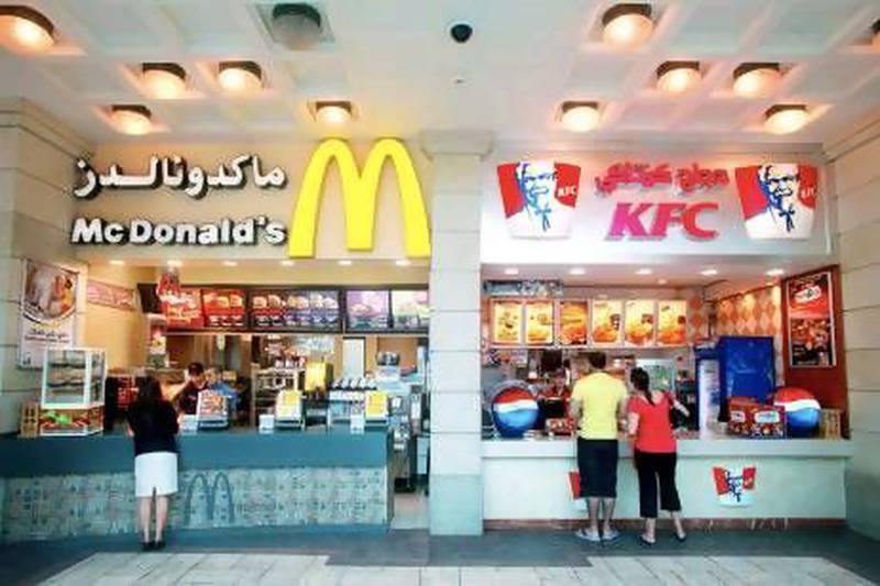 Customers buy food at a McDonald's and a KFC fast food outlet at the Mercato Mall in Dubai.
