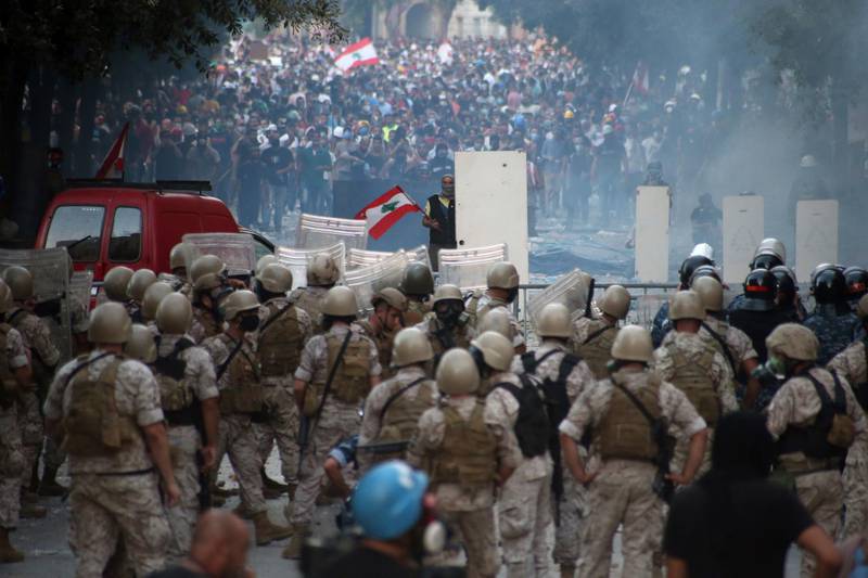 Lebanese anti-government protesters face off with riot police.  EPA