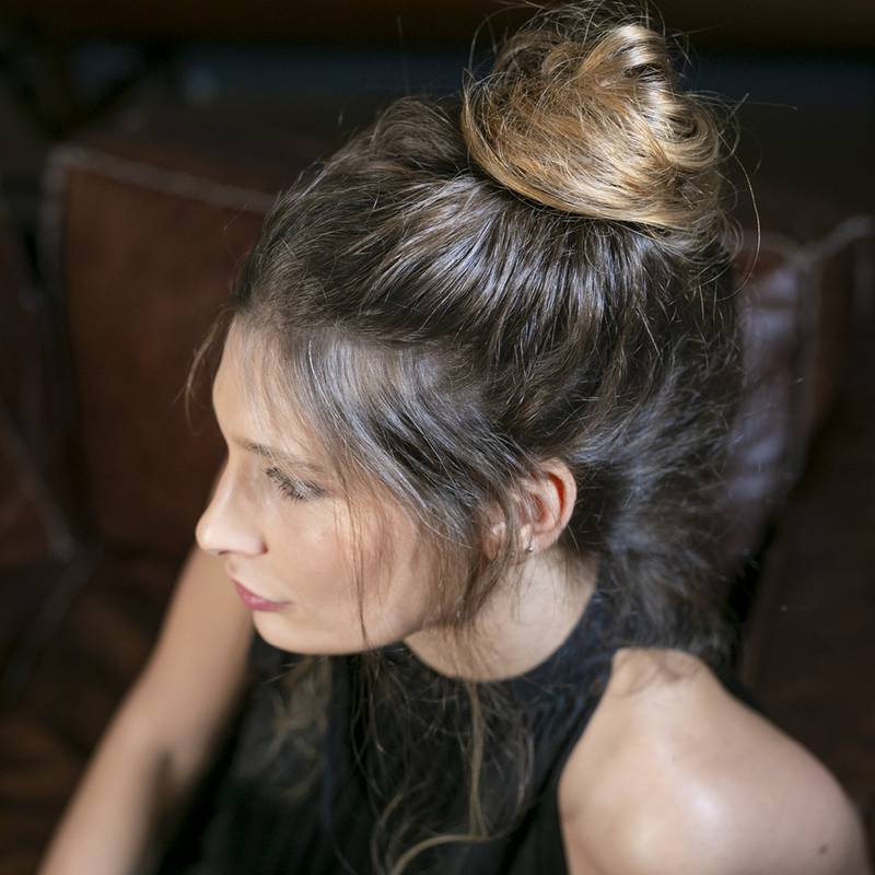 A messy bun is an attractive way to style unstraightened hair. Photo: Rossano Ferretti