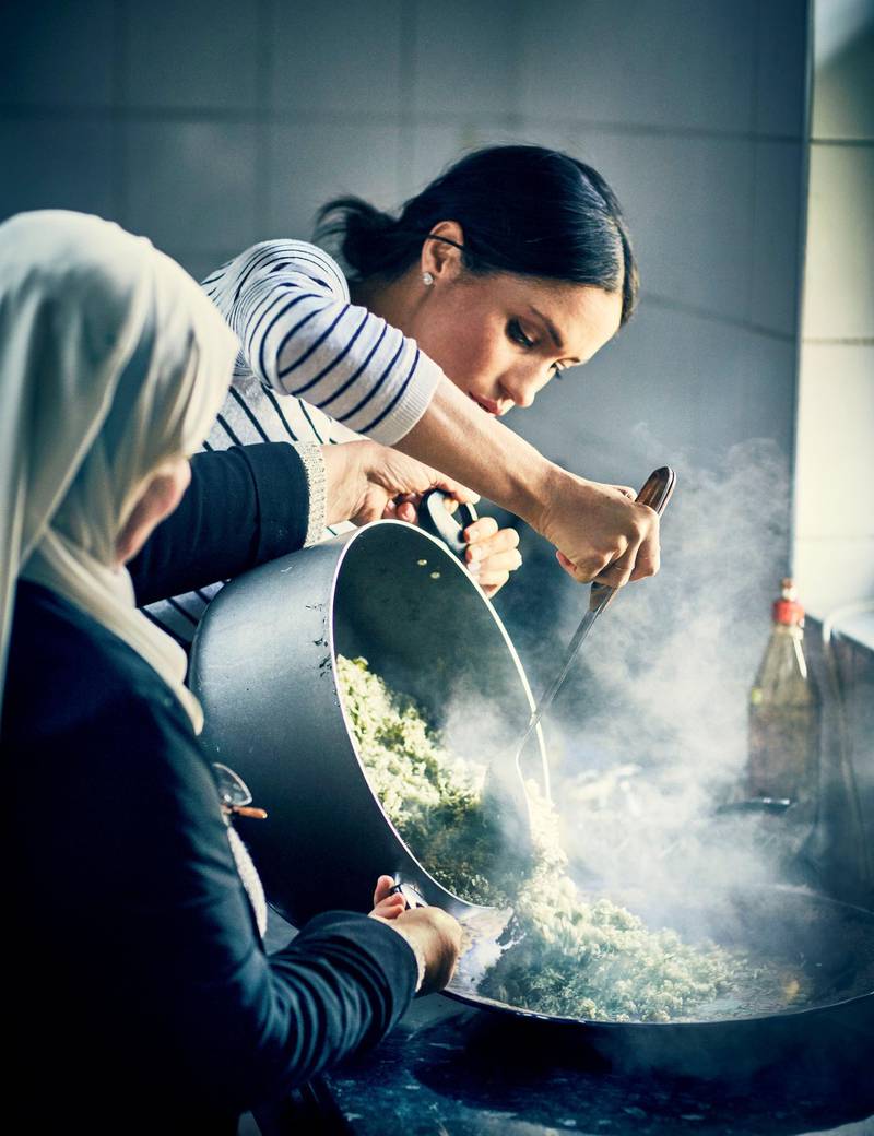 Britain's Meghan, Duchess of Sussex, cooks with women in the Hubb Community Kitchen at the Al Manaar Muslim Cultural Heritage Centre in west London Reuters