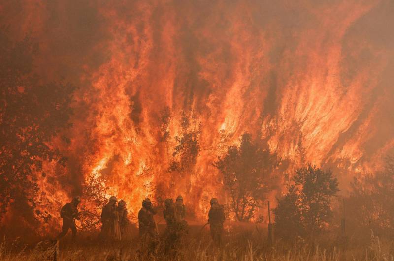 Firefighters battle a blaze in Pumarejo de Tera near Zamora in northern Spain. Firefighters continue to fight several fires in Spain on the last day of an extreme heat wave, June 18, 2022.  AFP