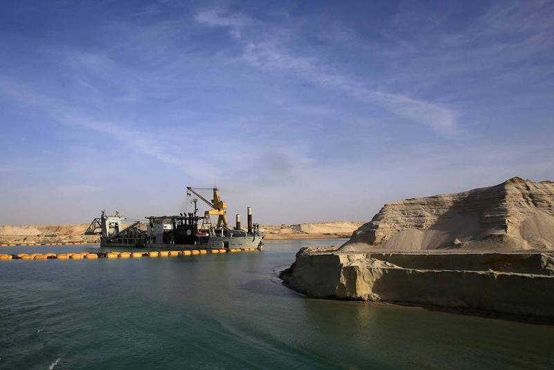 A dredger works on a section of the New Suez Canal during a media tour in Ismailia, Egypt. Hassan Ammar / AP Photo
