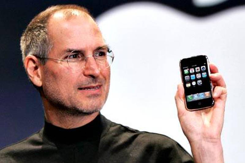 FILE - In this Jan. 9, 2007 file phtoo, Apple CEO Steve Jobs holds up an Apple iPhone at the MacWorld Conference in San Francisco. Jobs the CEO, Jobs the technologist and futurist, Jobs the inventor and innovator and refiner of others' ideas: All of them, in the end, relied upon another Steve Jobs who sewed the others together and bottled their lightning: Steve Jobs the storyteller, spinning the tale of our age and of his own success, and making it happen as he went.  (AP Photo/Paul Sakuma, File)