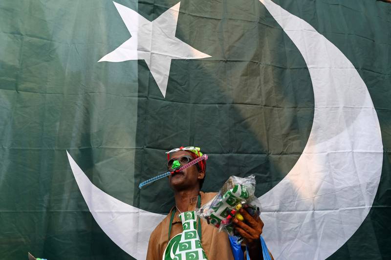 A roadside trader sells flags in Lahore. AFP