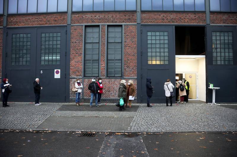 Visitors queue outside a Covid-19 vaccination site at Berlin Arena in Berlin, Germany. Bloomberg