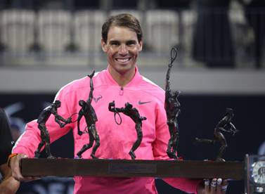 Rafael Nadal holds his trophy after winning an exhibition game against compatriot David Ferrer to inaugurate the Rafa Nadal Academy Kuwait. AFP