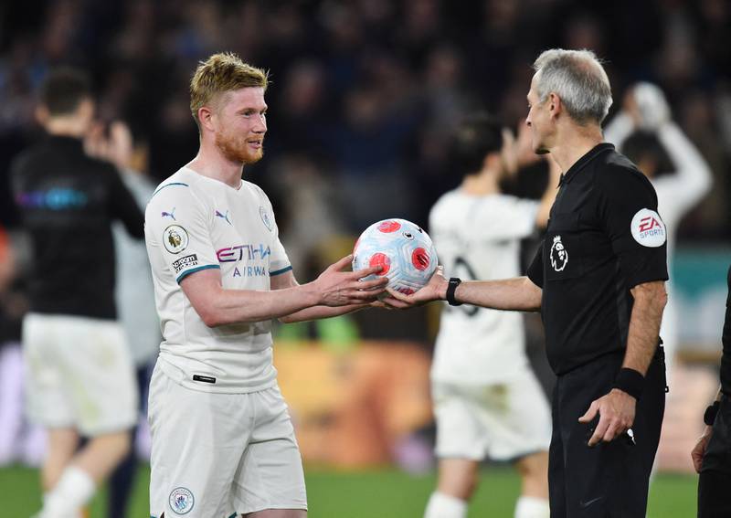 Kevin De Bruyne is handed the match ball by referee Martin Atkinson. Reuters