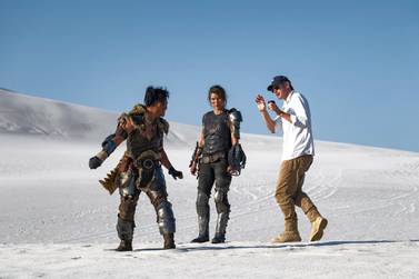 Actor Tony Jaa, left, and actress Milla Jovovich, with director Paul W S Anderson on the set of ‘Monster Hunter’ .Coco Van Oppens Photography