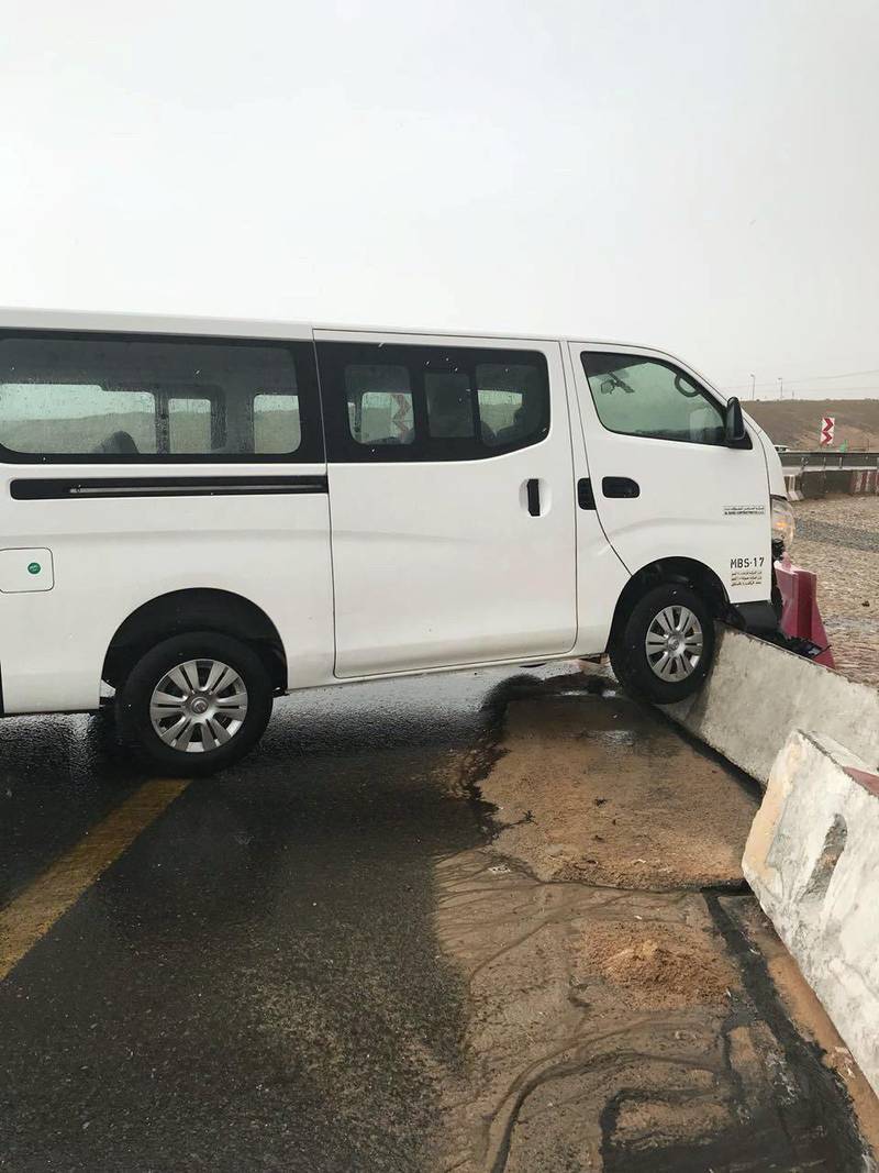 A van lies battered after its driver ran into difficulties. Dubai traffic police