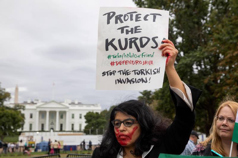 A woman joins other people protesting against an expected military incursion by Turkey into Kurdish areas of northern Syria, at Lafayette Square in front of the White House in Washington.  EPA