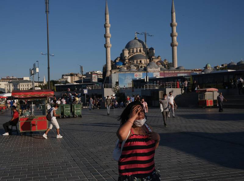 A woman walks in front of the Yeni Mosque at the Eminonu Square, amid the ongoing coronavirus pandemic in Istanbul, Turkey. EPA