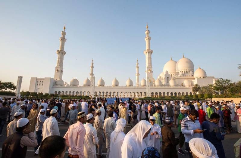 Abu Dhabi, UNITED ARAB EMIRATES - A family gathers for a photo opportunity after performing morning prayers on the first day of Eid-Al Fitr at the Sheikh Zayed Grand Mosque.  Leslie Pableo for The National